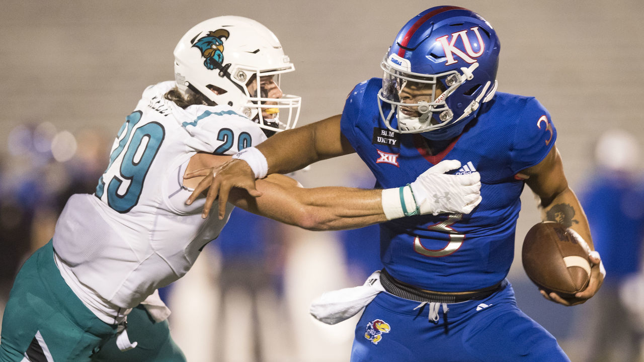 LAWRENCE, KS - SEPTEMBER 12: Quarterback Miles Kendrick #3 of the Kansas Jayhawks runs the ball against linebacker Silas Kelly #29 of the Coastal Carolina Chanticleers during the game at Memorial Stadium on September 12, 2020 in Lawrence, Kansas.