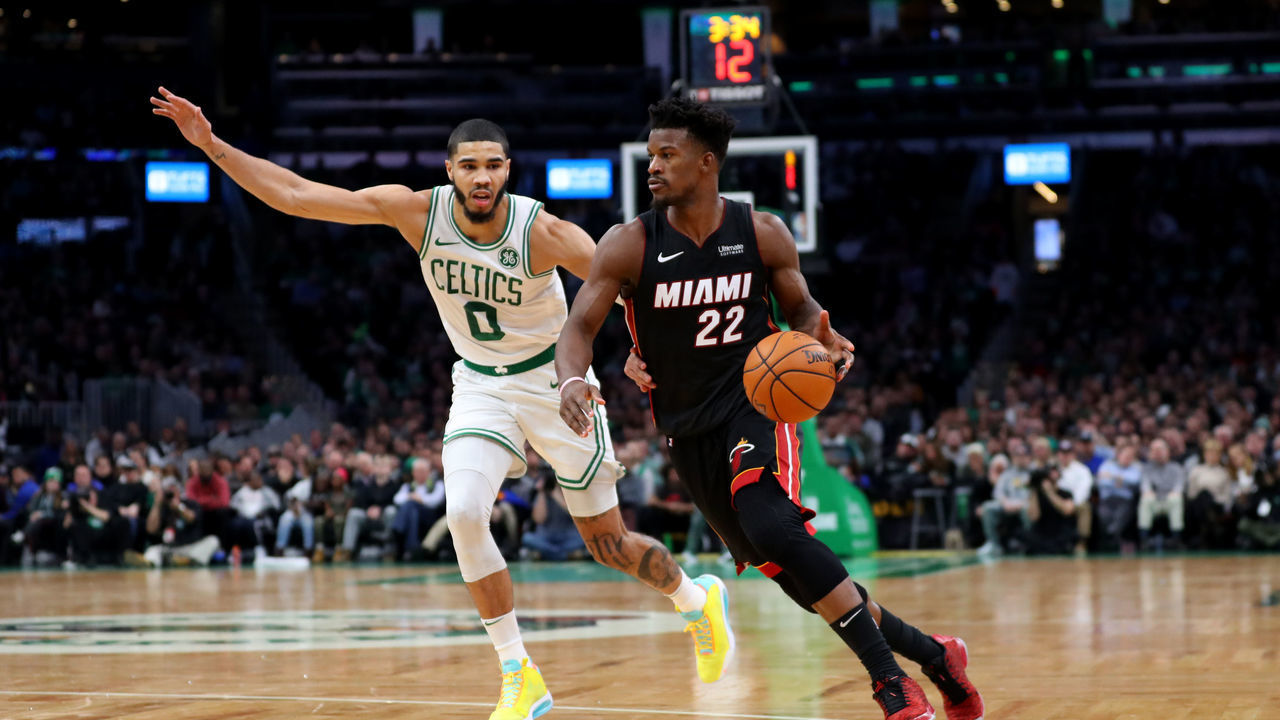 BOSTON, MASSACHUSETTS - DECEMBER 04: Jayson Tatum #0 of the Boston Celtics defends Jimmy Butler #22 of the Miami Heat during the first half of the game between the Boston Celtics and the Miami Heat at TD Garden on December 04, 2019 in Boston, Massachusetts.
