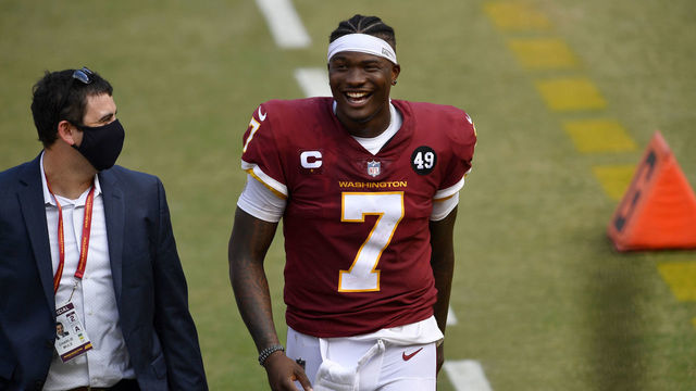 LANDOVER, MD - SEPTEMBER 13: Washington quarterback Dwayne Haskins, Jr. (7) smiles as he walks off the field with Charles Mule after the Philadelphia Eagles vs. Washington Football Team NFL game at FedEx Field on September 13, 2020 in Landover, MD.