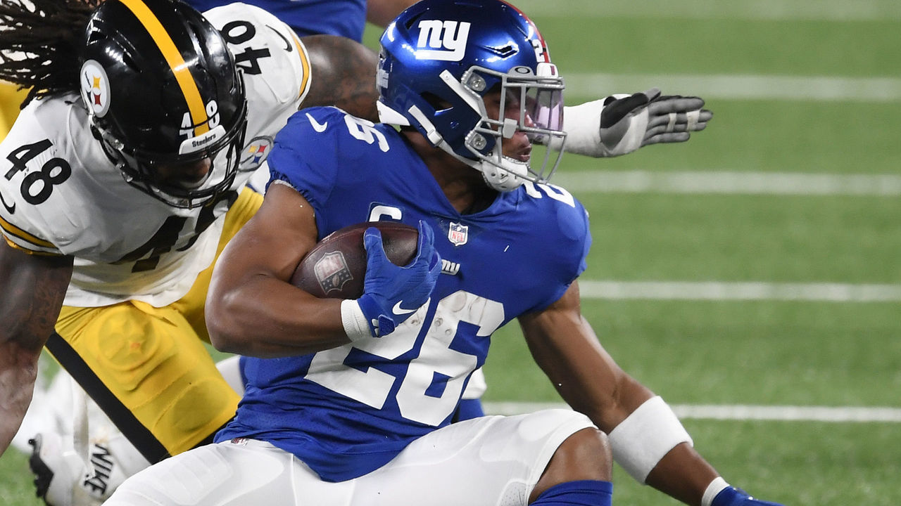 EAST RUTHERFORD, NEW JERSEY - SEPTEMBER 14: Saquon Barkley #26 of the New York Giants carries the ball as Bud Dupree #48 of the Pittsburgh Steelers defends during the first half at MetLife Stadium on September 14, 2020 in East Rutherford, New Jersey.