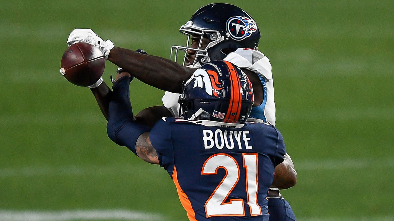 DENVER, CO - SEPTEMBER 14: A.J. Bouye #21 of the Denver Broncos breaks up a pass intended for A.J. Brown #11 of the Tennessee Titans in the first quarter of a game at Empower Field at Mile High on September 14, 2020 in Denver, Colorado.