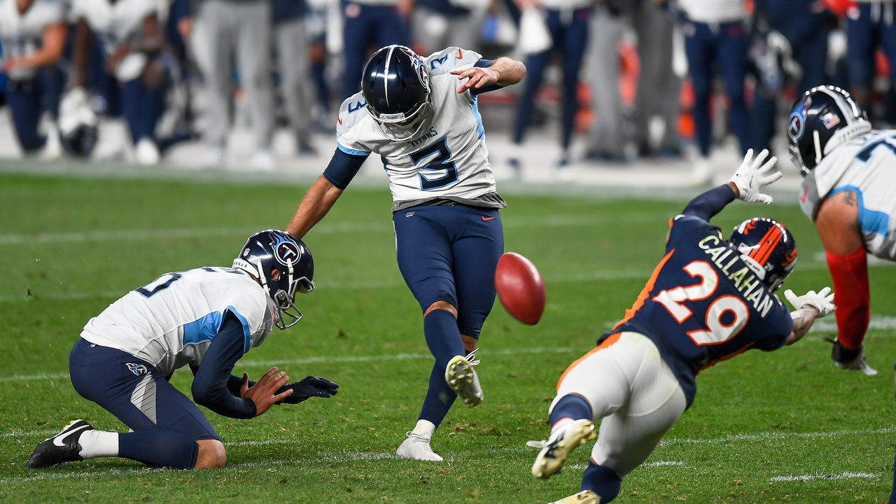 DENVER, CO - SEPTEMBER 14: Stephen Gostkowski #3 of the Tennessee Titans kicks a go-ahead fourth quarter field goal as Brett Kern #6 holds and Bryce Callahan #29 of the Denver Broncos covers the play during a game at Empower Field at Mile High on September 14, 2020 in Denver, Colorado.