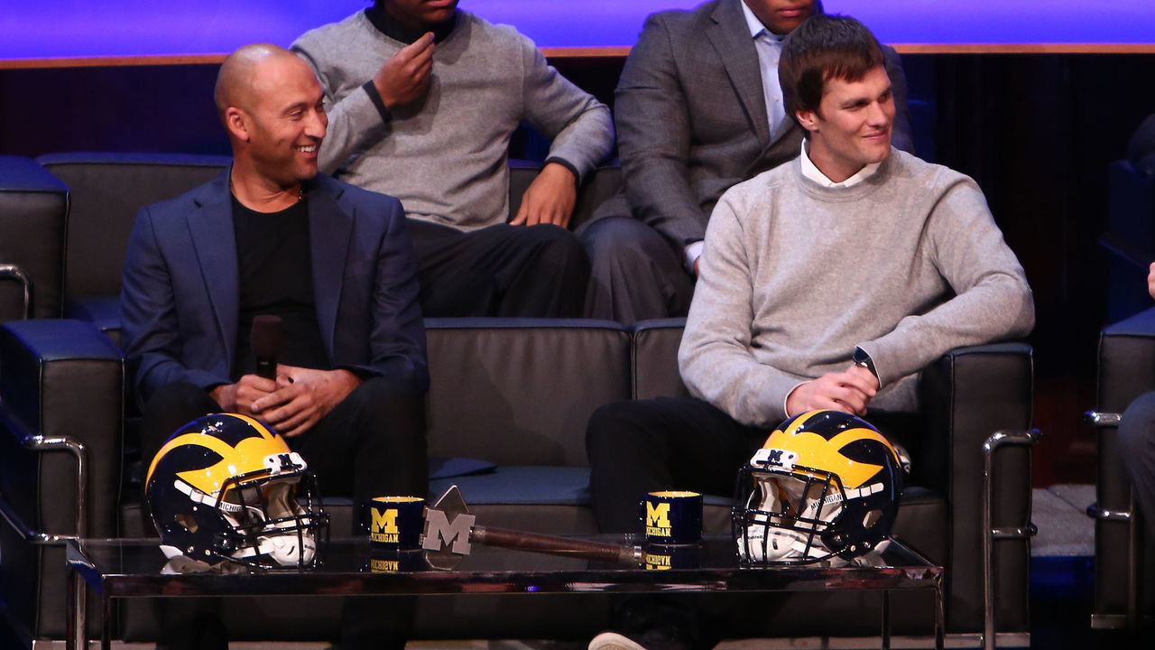 ANN ARBOR, MI - FEBRUARY 3: Derek Jeter, former New York Yankee (L) and Tom Brady, former Michigan Wolverine and current NFL quarterback (C) talk with Head coach Jim Harbaugh of the Michigan Wolverines (R) during the Michigan Signing of the Stars event at Hill Auditorium on February 3, 2016 in Ann Arbor, Michigan.