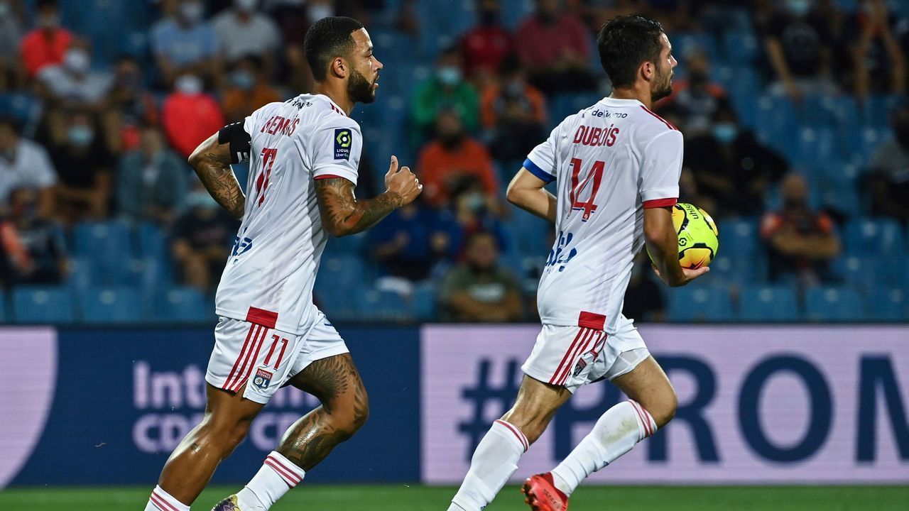 Lyon's Dutch forward Memphis Depay (L) celebrates after scoring during the French L1 football match between Montpellier Herault SC and Olympique Lyonnais at the Mosson stadium in Montpellier, southern France on September 15, 2020.