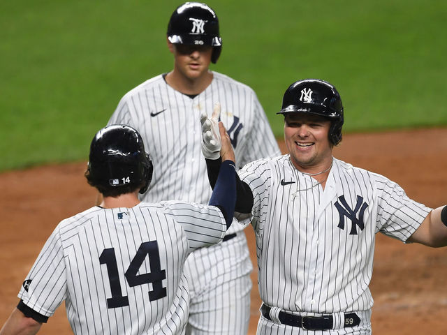 NEW YORK, NEW YORK - SEPTEMBER 15: Luke Voit #59 of the New York Yankees celebrates with Tyler Wade #14 after hitting a three-run home run during the second inning against the Toronto Blue Jays at Yankee Stadium on September 15, 2020 in the Bronx borough of New York City.