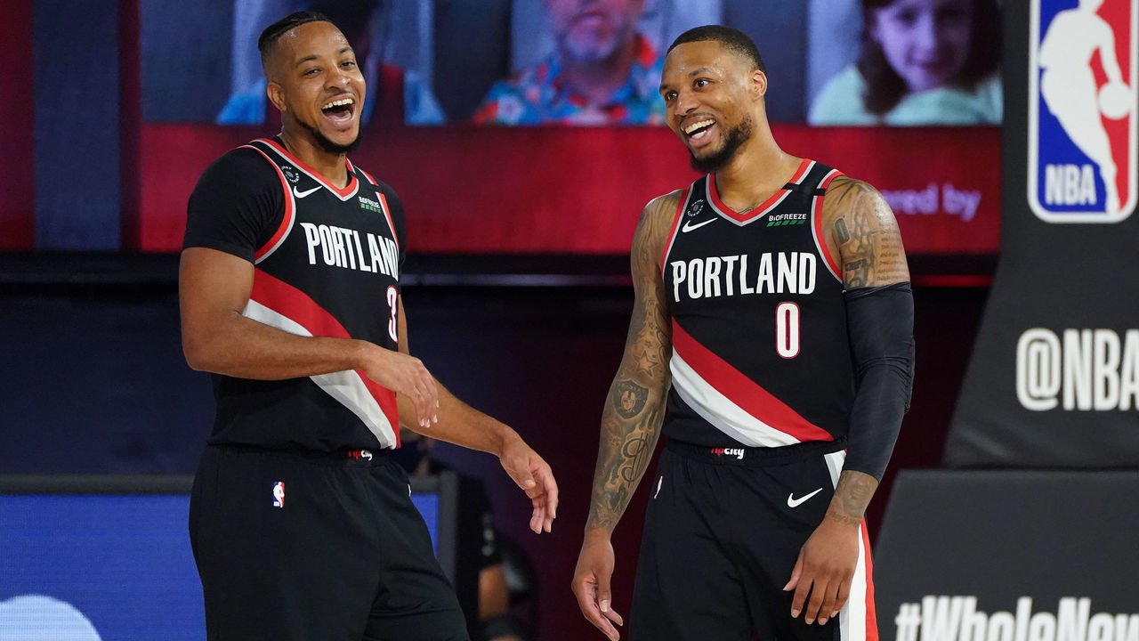 ORLANDO, FL - AUGUST 15: CJ McCollum #3 andDamian Lillard #0 of the Portland Trail Blazers smile and laugh on the court after the Western Conference Play in Game on August 15, 2020 in Orlando, Florida at The Field House at ESPN Wide World of Sports. NOTE TO USER: User expressly acknowledges and agrees that, by downloading and/or using this photograph, user is consenting to the terms and conditions of the Getty Images License Agreement. Mandatory Copyright Notice: Copyright 2020 NBAE