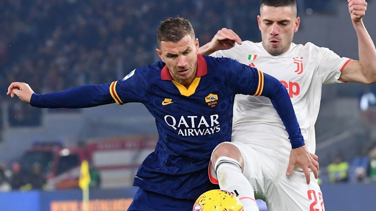 Juventus' Turkish defender Merih Demiral (R) tackles AS Roma's Bosnian forward Edin Dzeko during the Italian Serie A football match AS Roma vs Juventus on January 12, 2020 at the Olympic stadium in Rome.