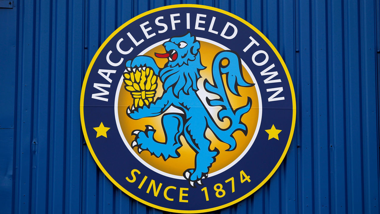 MACCLESFIELD, ENGLAND - AUGUST 3: The Macclesfield Town logo is seen displayed on the side of the main stand before the Pre Season Friendly match between Macclesfield Town and Stoke City at Moss Rose on August 3, 2013 in Macclesfield, England