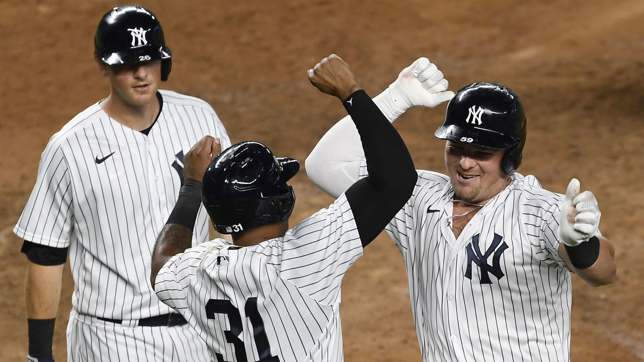 NEW YORK, NEW YORK - SEPTEMBER 16: Luke Voit #59 of the New York Yankees celebrates with Aaron Hicks #31 and DJ LeMahieu #26 after Voit hitting a three-run home run during the sixth inning against the Toronto Blue Jays at Yankee Stadium on September 16, 2020 in the Bronx borough of New York City.