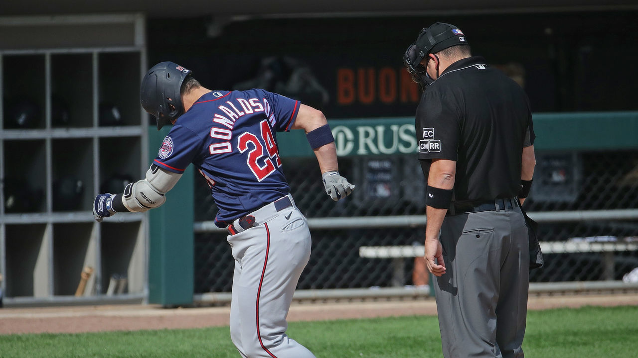 CHICAGO, ILLINOIS - SEPTEMBER 17: Josh Donaldson #24 of the Minnesota Twins kicks dirt on umpire Dan Bellino #2 after hitting a home run following an argument over a called strike in the 6th inning against the Chicago White Sox at Guaranteed Rate Field on September 17, 2020 in Chicago, Illinois. Donaldson was ejected by Bellino after the incident.