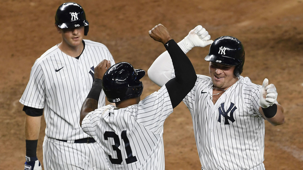 NEW YORK, NEW YORK - SEPTEMBER 16: Luke Voit #59 of the New York Yankees celebrates with Aaron Hicks #31 and DJ LeMahieu #26 after Voit hitting a three-run home run during the sixth inning against the Toronto Blue Jays at Yankee Stadium on September 16, 2020 in the Bronx borough of New York City.