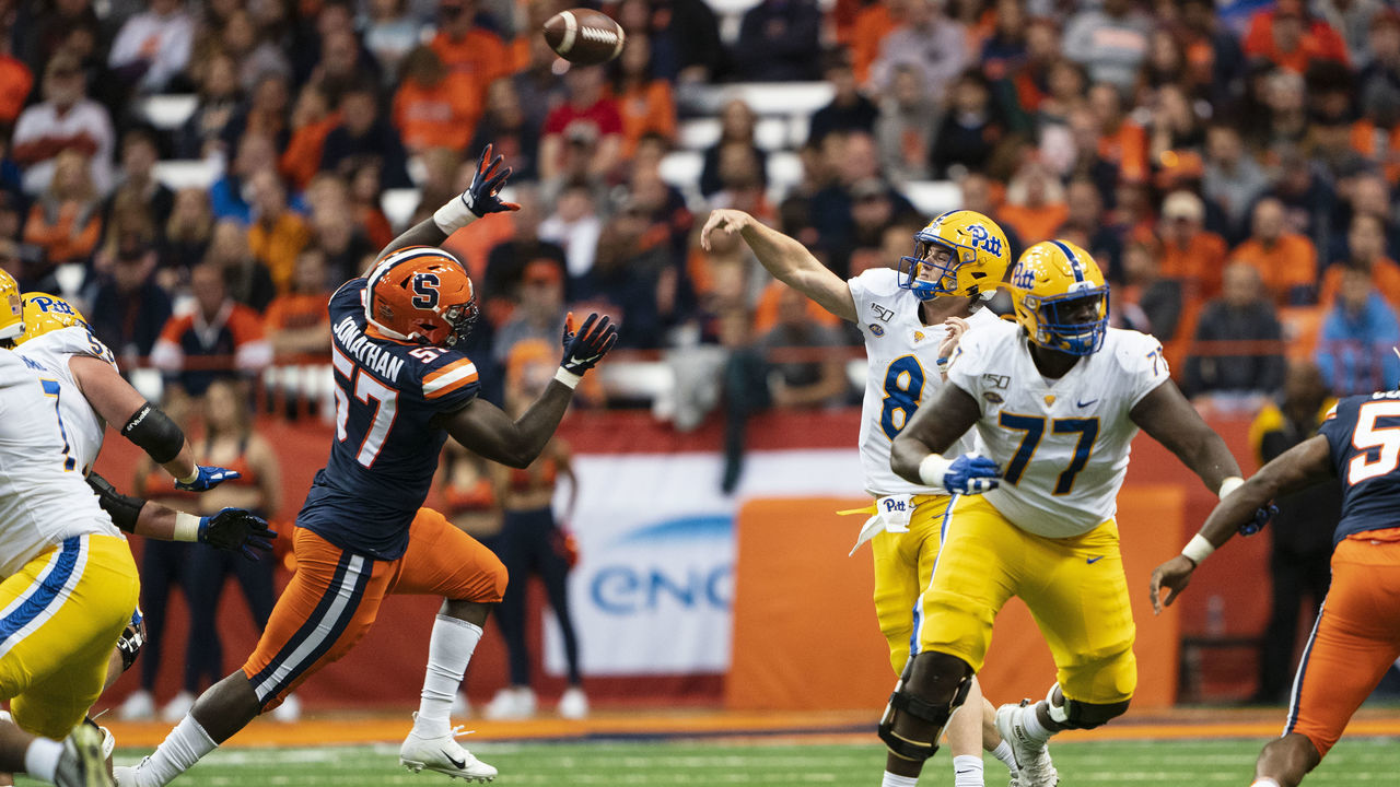 SYRACUSE, NY - OCTOBER 18: Pittsburgh Panthers Quarterback Kenny Pickett (8) throws the ball with Syracuse Orange Defensive Lineman Kingsley Jonathan (57) defending and Pittsburgh Panthers Offensive Lineman Carter Warren (77) blocking during the second quarter of the game between the Pittsburgh Panthers and the Syracuse Orange on October 18, 2019, at the Carrier Dome in Syracuse, NY.