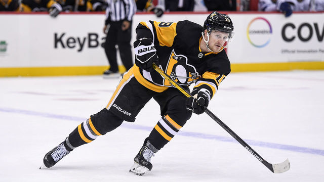 PITTSBURGH, PA - FEBRUARY 11: Pittsburgh Penguins Left Wing Jared McCann (19) passes the puck during the overtime period in the NHL game between the Pittsburgh Penguins and the Tampa Bay Lightning on February 11, 2020, at PPG Paints Arena in Pittsburgh, PA.