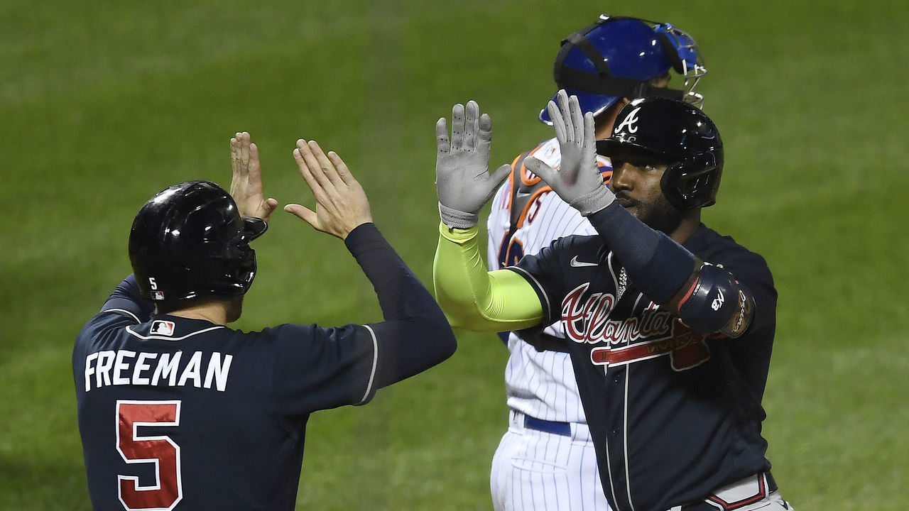 NEW YORK, NEW YORK - SEPTEMBER 18: Marcell Ozuna #20 of the Atlanta Braves celebrates with Freddie Freeman #5 after hitting a two-run home run during the second inning against the New York Mets at Citi Field on September 18, 2020 in the Queens borough of New York City.