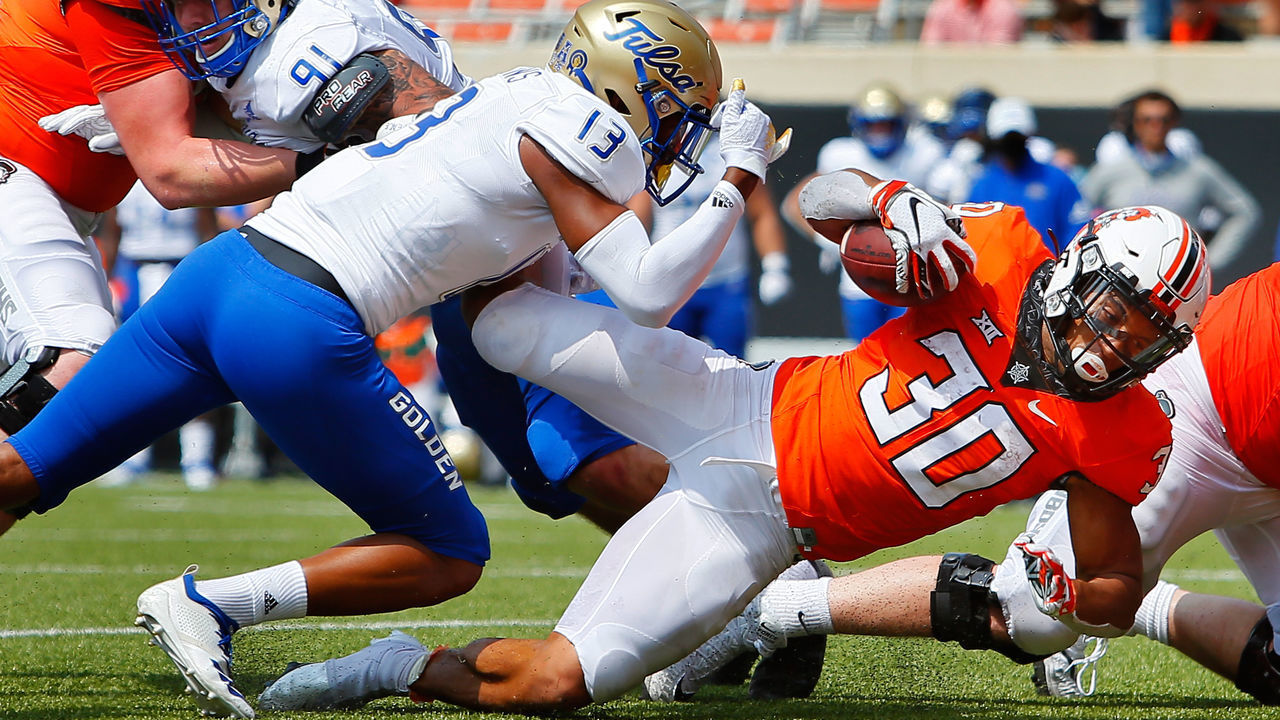 STILLWATER, OK - SEPTEMBER 19: Running back Chuba Hubbard #30 of the Oklahoma State Cowboys pushes past a tackle to score a touchdown against safety Lamar Mullins #13 of the Tulsa Golden Hurricanes in the fourth quarter on September 19, 2020 at Boone Pickens Stadium in Stillwater, Oklahoma. OSU won 16-7.