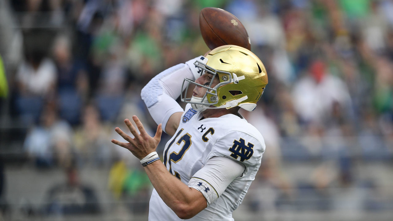 ORLANDO, FL - DECEMBER 28: Notre Dame Fighting Irish quarterback Ian Book (12) throws a pass during the second half of the Camping World Bowl between the Notre Dame Fighting Irish and the Iowa State Cyclones on December 28, 2019, at Camping World Stadium in Orlando, FL.
