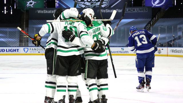 EDMONTON, ALBERTA - SEPTEMBER 19: Joel Kiviranta #25 of the Dallas Stars celebrates with Roope Hintz #24, Corey Perry #10 and Esa Lindell #23 as Cedric Paquette #13 of the Tampa Bay Lightning skates away after Kiviranta scored in the second period of Game One of the NHL Stanley Cup Final between the Dallas Stars and the Tampa Bay Lightning at Rogers Place on September 19, 2020 in Edmonton, Alberta, Canada.