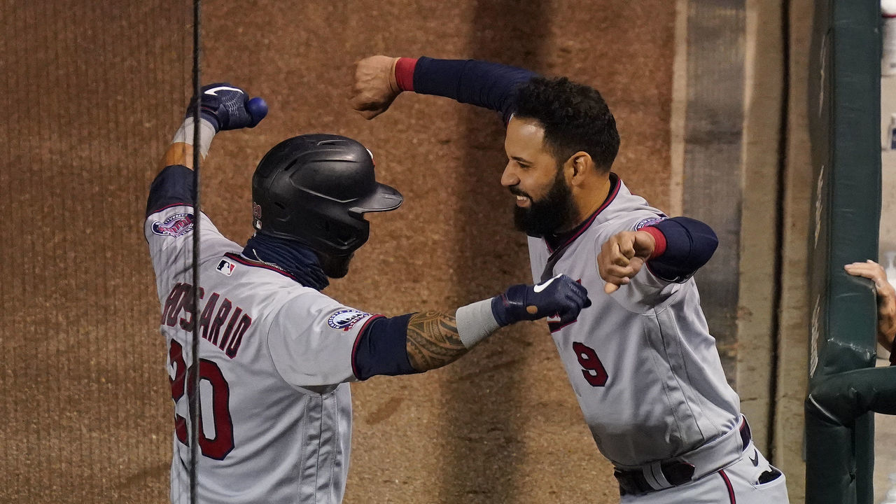 CHICAGO, ILLINOIS - SEPTEMBER 19: Eddie Rosario #20 of the Minnesota Twins is congratulated by Marwin Gonzalez #9 following his home run during the first inning of a game against the Chicago Cubs at Wrigley Field on September 19, 2020 in Chicago, Illinois.