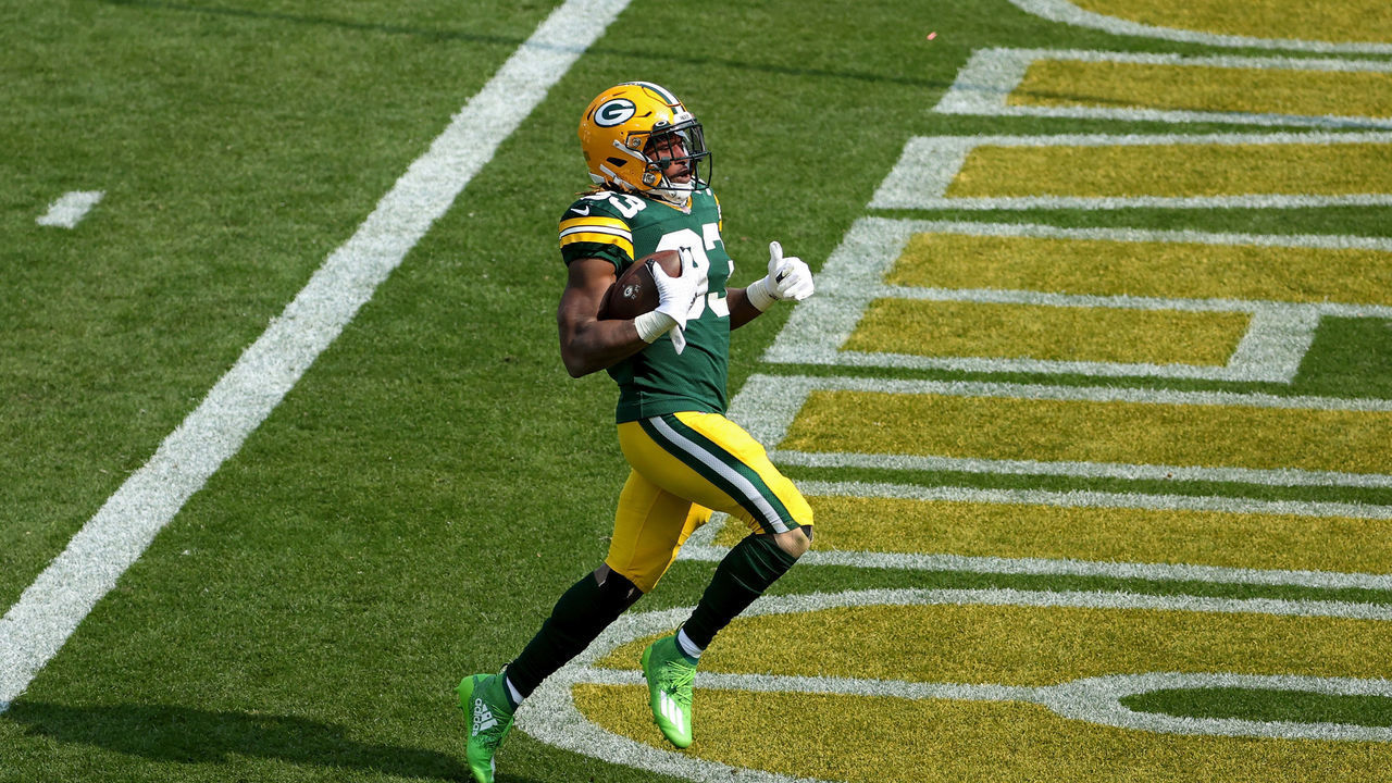 GREEN BAY, WISCONSIN - SEPTEMBER 20: Aaron Jones #33 of the Green Bay Packers scores a touchdown in the third quarter against the Detroit Lions at Lambeau Field on September 20, 2020 in Green Bay, Wisconsin.