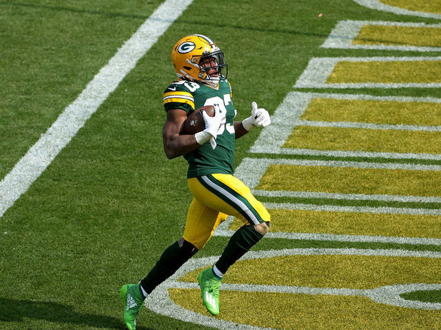 GREEN BAY, WISCONSIN - SEPTEMBER 20: Aaron Jones #33 of the Green Bay Packers scores a touchdown in the third quarter against the Detroit Lions at Lambeau Field on September 20, 2020 in Green Bay, Wisconsin.