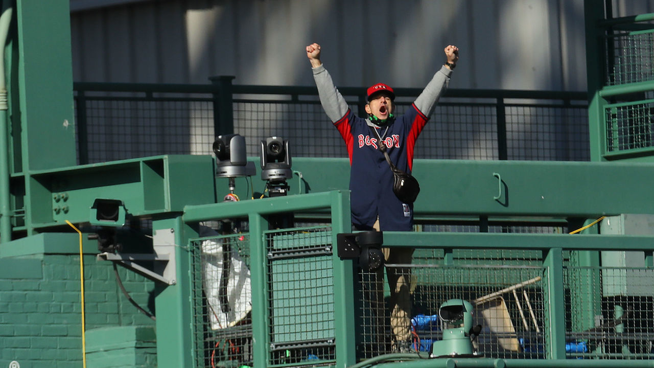 BOSTON, MASSACHUSETTS - SEPTEMBER 20: A man wearing a Red Sox jersey stands on the video camera deck in center field delaying the game between the Boston Red Sox and the New York Yankees at Fenway Park on September 20, 2020 in Boston, Massachusetts.