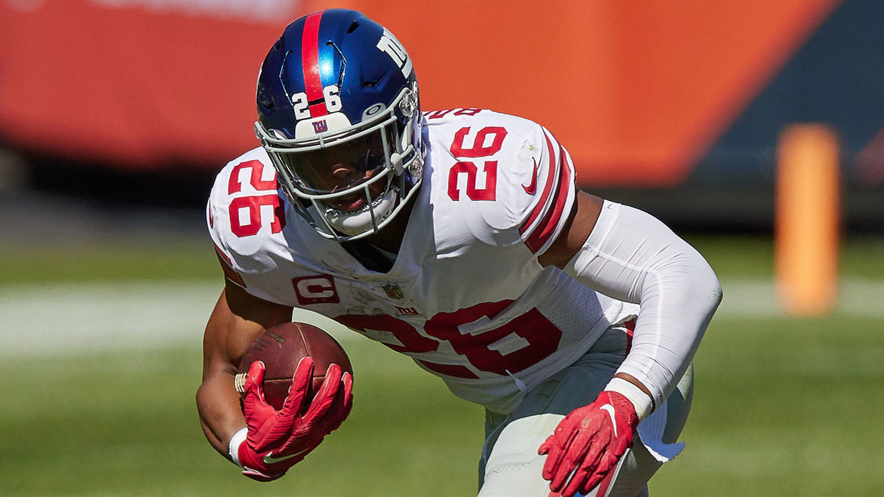 CHICAGO, IL - SEPTEMBER 20: New York Giants running back Saquon Barkley (26) leaps in the air with the football in action during a game between the Chicago Bears and the New York Giants on September 20, 2020 at Soldier Field in Chicago, IL.