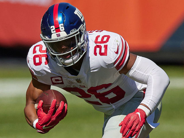 CHICAGO, IL - SEPTEMBER 20: New York Giants running back Saquon Barkley (26) leaps in the air with the football in action during a game between the Chicago Bears and the New York Giants on September 20, 2020 at Soldier Field in Chicago, IL.