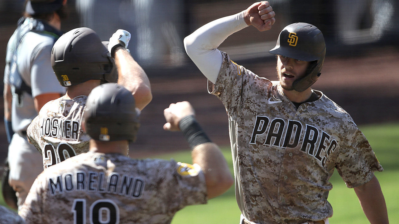 SAN DIEGO, CALIFORNIA - SEPTEMBER 20: Eric Hosmer #30 and Mitch Moreland #18 congratulate Wil Myers #4 of the San Diego Padres at home plate after his three-run homerun during the sixth inning of a game against the Seattle Mariners at PETCO Park on September 20, 2020 in San Diego, California. The game was moved to San Diego due to air quality concerns in Seattle from the wildfires.