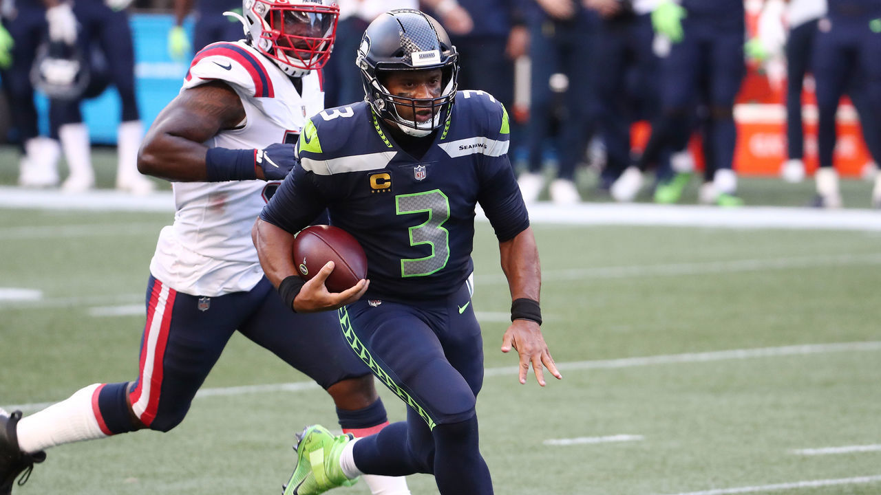 SEATTLE, WASHINGTON - SEPTEMBER 20: Russell Wilson #3 of the Seattle Seahawks runs with the ball as he is chased by Ja'Whaun Bentley #51 of the New England Patriots during the first quarter at CenturyLink Field on September 20, 2020 in Seattle, Washington.