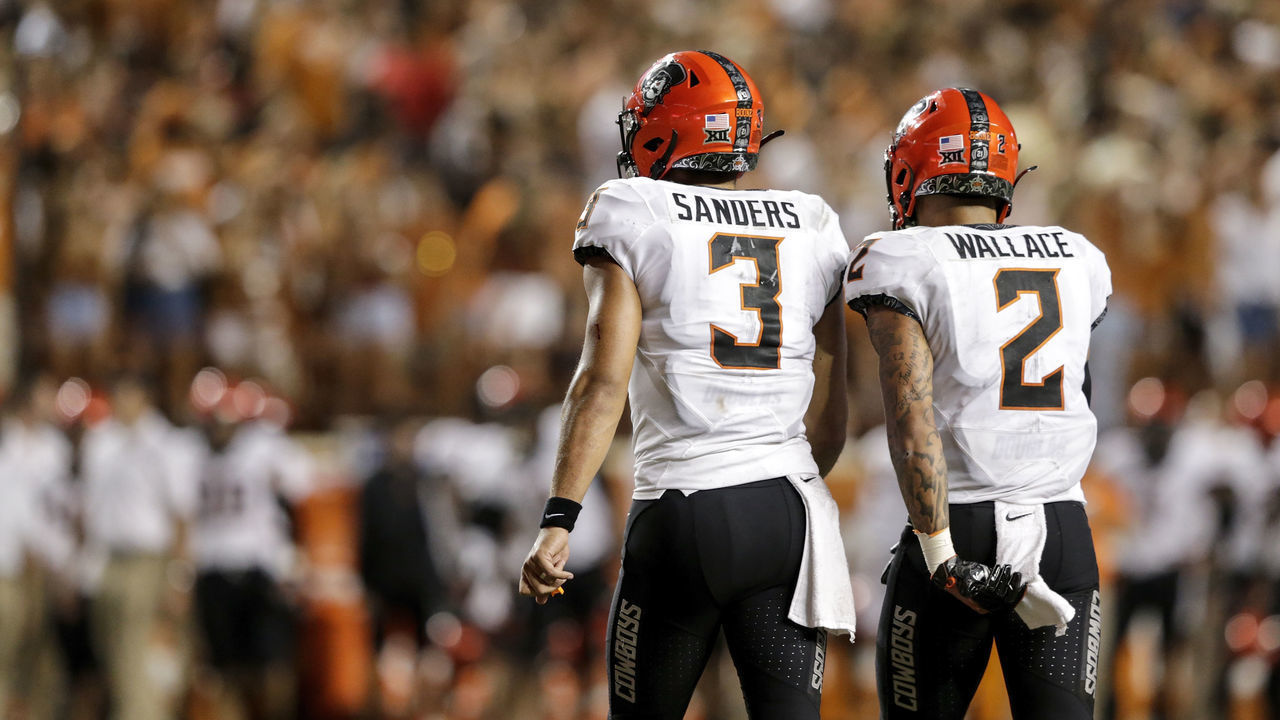 AUSTIN, TX - SEPTEMBER 21: Spencer Sanders #3 of the Oklahoma State Cowboys and Tylan Wallace #2 walk to the sideline in the fourth quarter against the Texas Longhorns at Darrell K Royal-Texas Memorial Stadium on September 21, 2019 in Austin, Texas.