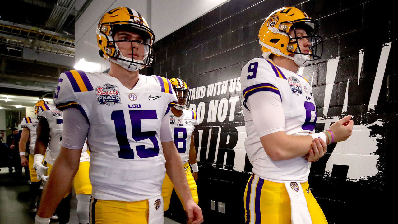 ATLANTA, GEORGIA - DECEMBER 28: Quarterbacks Joe Burrow #9 and Myles Brennan #15 of the LSU Tigers walk out of the tunnel to take on the LSU Tigers in the Chick-fil-A Peach Bowl at Mercedes-Benz Stadium on December 28, 2019 in Atlanta, Georgia.