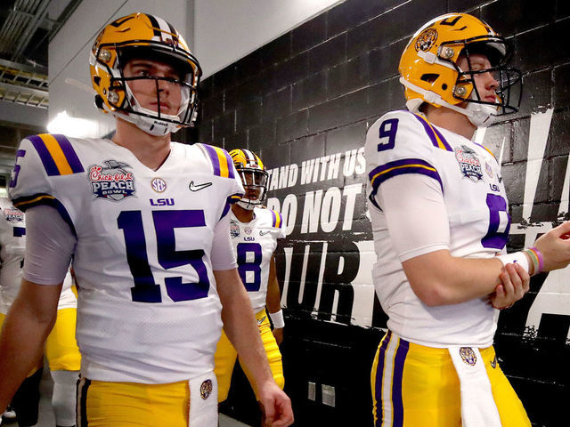 ATLANTA, GEORGIA - DECEMBER 28: Quarterbacks Joe Burrow #9 and Myles Brennan #15 of the LSU Tigers walk out of the tunnel to take on the LSU Tigers in the Chick-fil-A Peach Bowl at Mercedes-Benz Stadium on December 28, 2019 in Atlanta, Georgia.