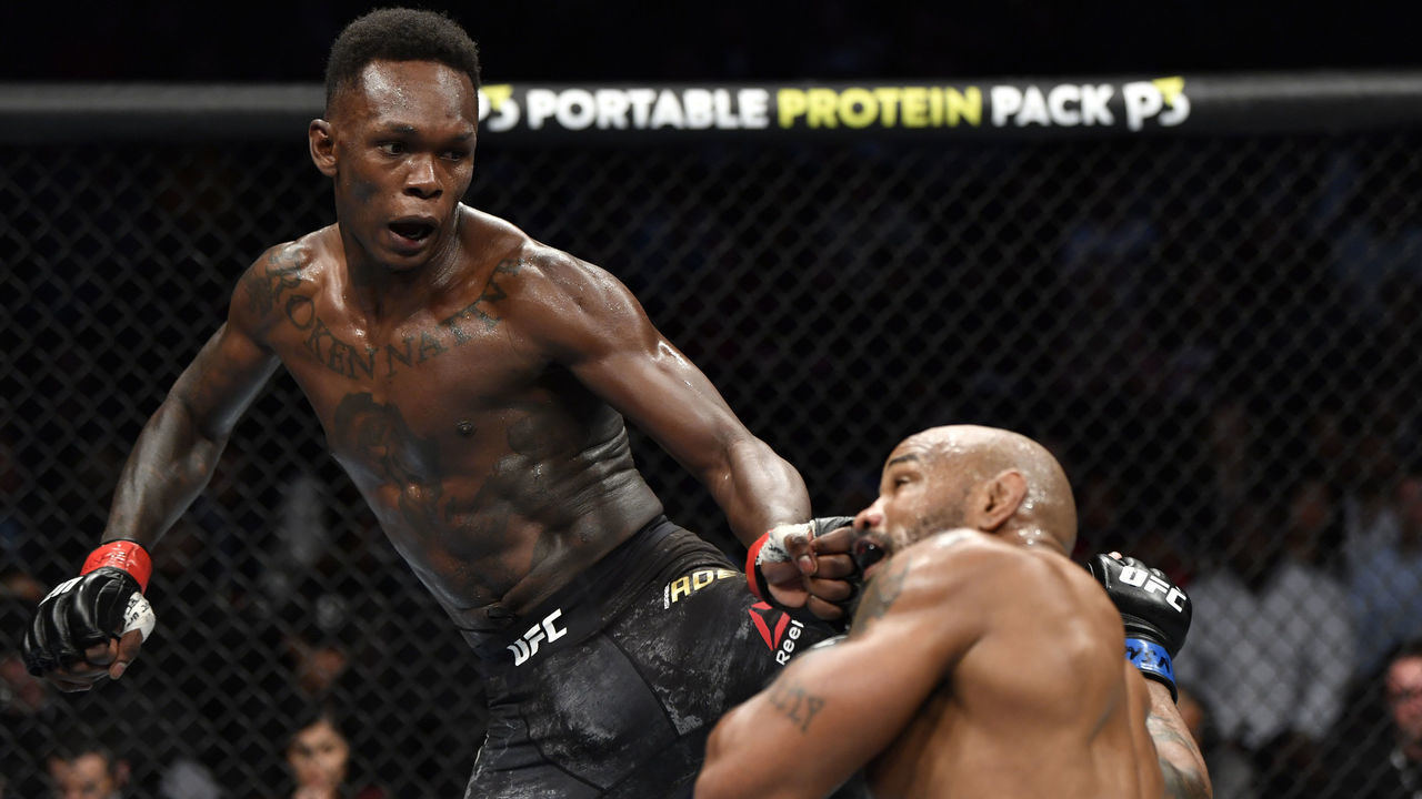 LAS VEGAS, NEVADA - MARCH 07: (L-R) Israel Adesanya of Nigeria kicks Yoel Romero of Cuba in their UFC middleweight championship fight during the UFC 248 event at T-Mobile Arena on March 07, 2020 in Las Vegas, Nevada.