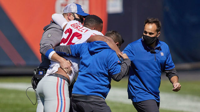 CHICAGO, IL - SEPTEMBER 20: New York Giants running back Saquon Barkley (26) is assisted off the field by New York Giants medical staff and trainers after suffering a torn ACL in action during a game between the Chicago Bears and the New York Giants on September 20, 2020 at Soldier Field in Chicago, IL.