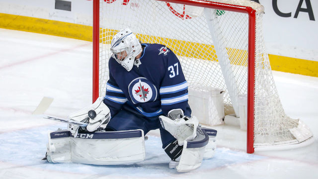WINNIPEG, MB - MARCH 6: Goaltender Connor Hellebuyck #37 of the Winnipeg Jets blocks the puck during first period action against the Vegas Golden Knights at the Bell MTS Place on March 6, 2020 in Winnipeg, Manitoba, Canada.