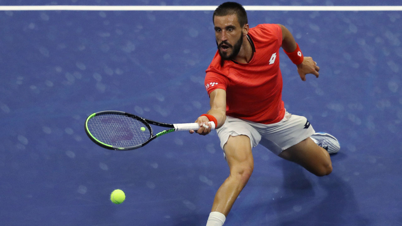 NEW YORK, NEW YORK - AUGUST 31: Damir Dzumhur of Bosnia and Herzegovina returns a volley during his Men's Singles first round match against Novak Djokovic of Serbia on Day One of the 2020 US Open at the USTA Billie Jean King National Tennis Center on August 31, 2020 in the Queens borough of New York City.