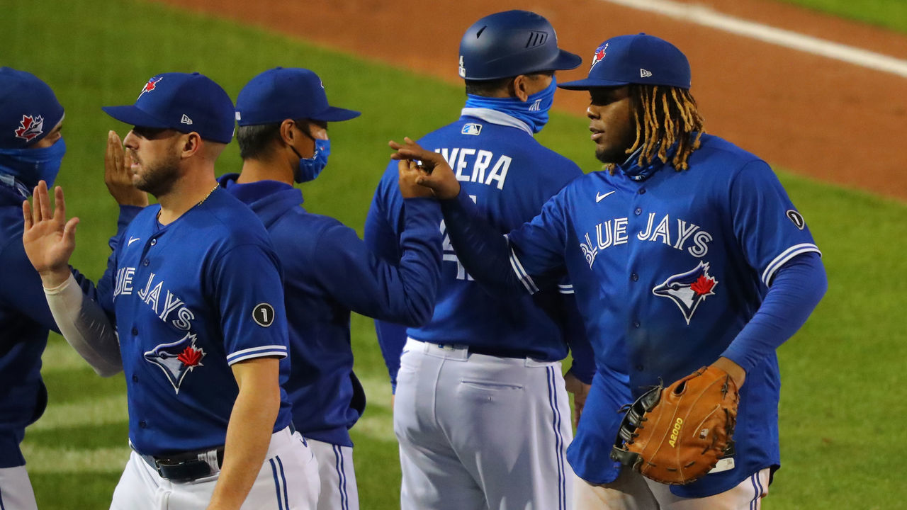 BUFFALO, NY - SEPTEMBER 23: Vladimir Guerrero Jr. #27 of the Toronto Blue Jays celebrates a win with teammates over the New York Yankees at Sahlen Field on September 23, 2020 in Buffalo, New York. The Blue Jays are the home team due to the Canadian governments policy on COVID-19, which prevents them from playing in their home stadium in Canada. Blue Jays beat the Yankees 14 to 1.