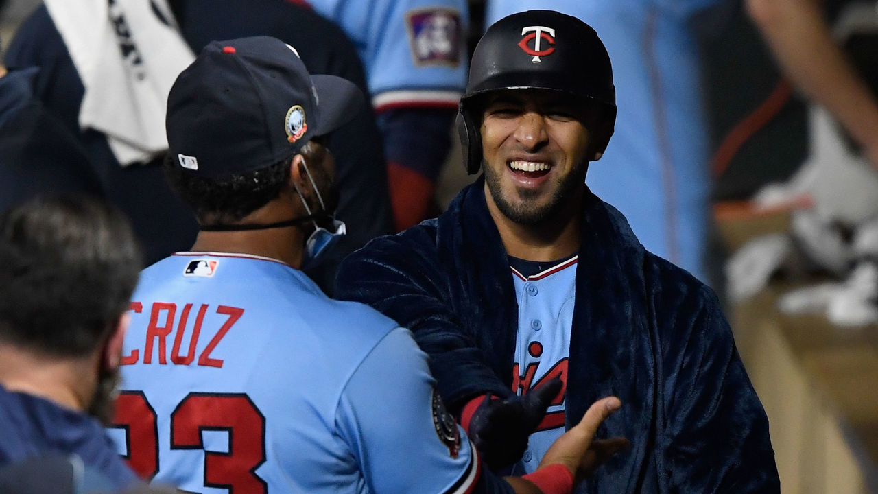 MINNEAPOLIS, MINNESOTA - SEPTEMBER 23: Nelson Cruz #23 of the Minnesota Twins congratulates teammate Eddie Rosario #20 on a two-run home run against the Detroit Tigers while Rosario wears a the robe of Cruz during the fifth inning of the game at Target Field on September 23, 2020 in Minneapolis, Minnesota. The Twins defeated the Tigers 7-6.
