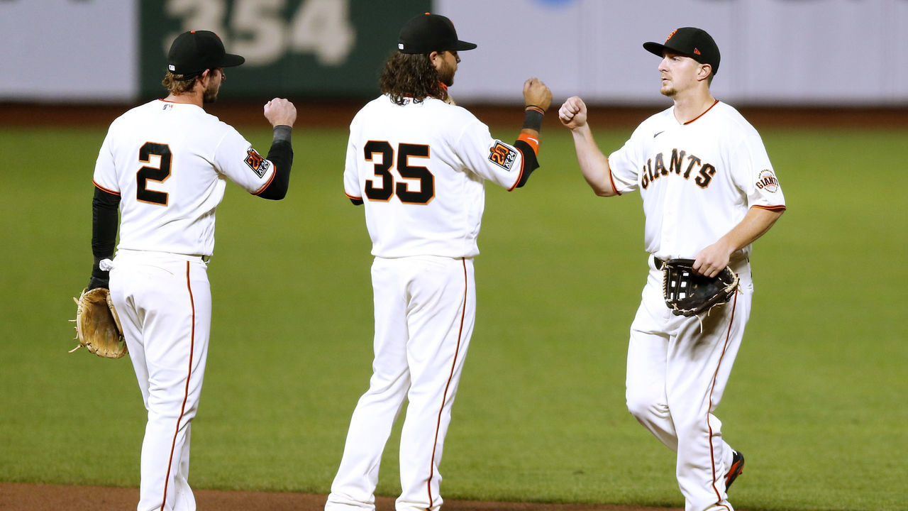 SAN FRANCISCO, CALIFORNIA - SEPTEMBER 23: Daniel Robertson #2, Brandon Crawford #35 and Alex Dickerson #12 of the San Francisco Giants celebrate after a win against the Colorado Rockies at Oracle Park on September 23, 2020 in San Francisco, California.