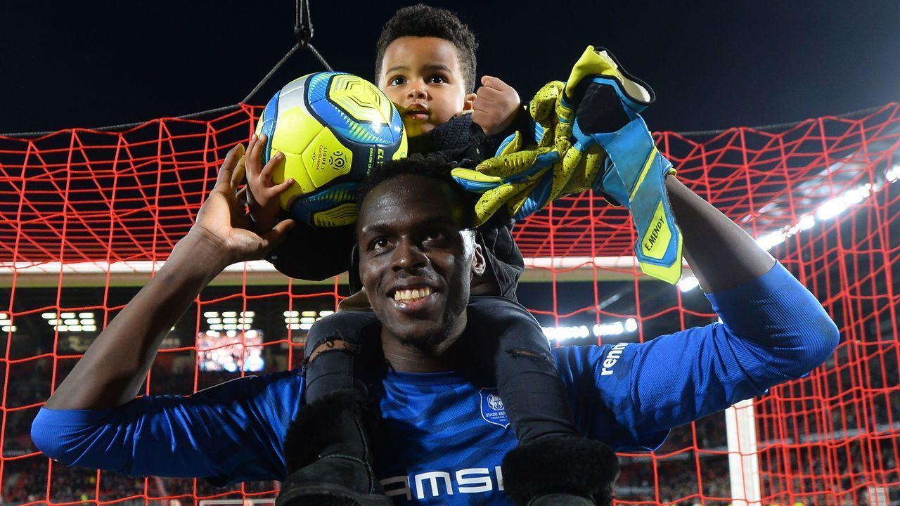 Rennes' Senegalese goalkeeper Edouard Mendy holds his son on his shoulders after the French L1 Football match between Stade Rennais Football Club and Nimes Olympique, on February 23, 2020, at the Roazhon Park, in Rennes, western France.