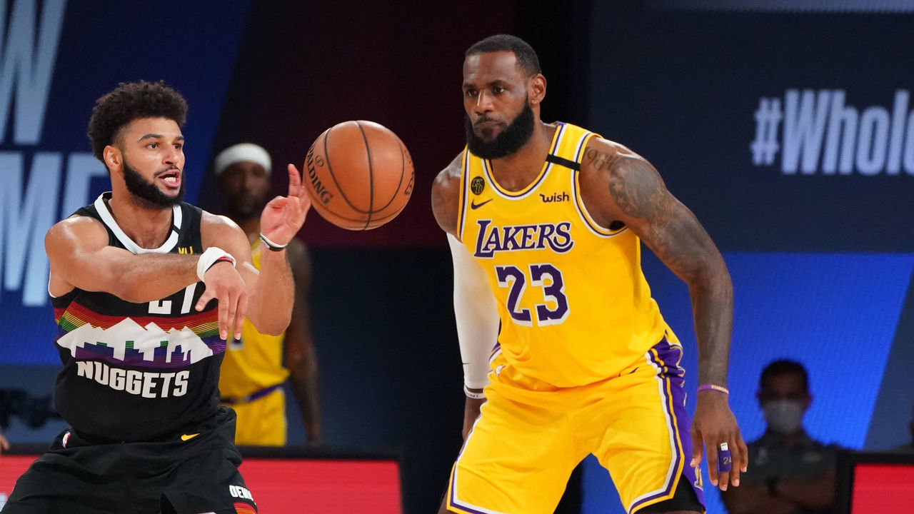 ORLANDO, FL - SEPTEMBER 24: Jamal Murray #27 of the Denver Nuggets passes the ball against LeBron James #23 of the Los Angeles Lakers during Game Four of the Western Conference Finals of the NBA Playoffs on September 24, 2020 at AdventHealth Arena at ESPN Wide World Of Sports Complex in Orlando, Florida. NOTE TO USER: User expressly acknowledges and agrees that, by downloading and/or using this Photograph, user is consenting to the terms and conditions of the Getty Images License Agreement. Mandatory Copyright Notice: Copyright 2020 NBAE