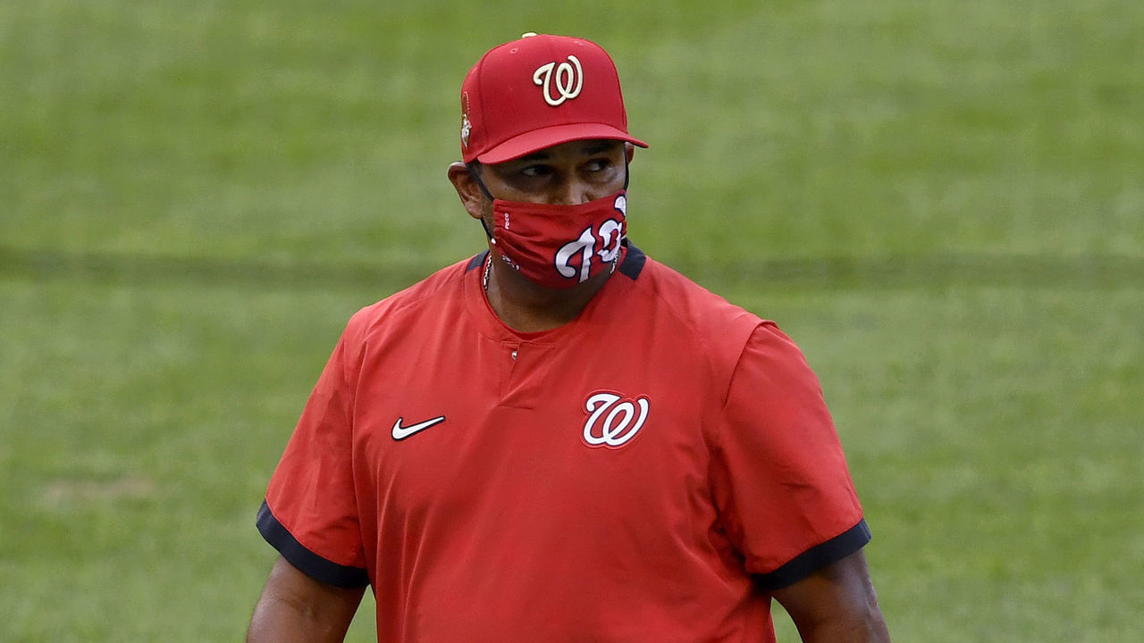 WASHINGTON, DC - AUGUST 22: Washington Nationals manager Dave Martinez (4) walks back to the dugout wearing a face mask after a mound visit during the Miami Marlins vs. Washington Nationals game one of a double header at Nationals Park on August 22, 2020 in Washington, D.C.