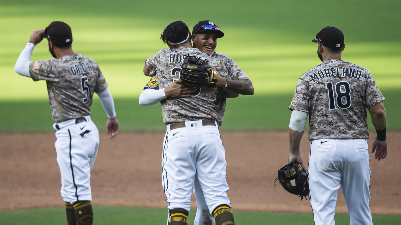 SAN DIEGO, CA - SEPTEMBER 20: Manny Machado #13 celebrates with Eric Hosmer #30 of the San Diego Padres after clinching a playoff berth and defeating the Seattle Mariners at PETCO Park on September 20, 2020 in San Diego, California.