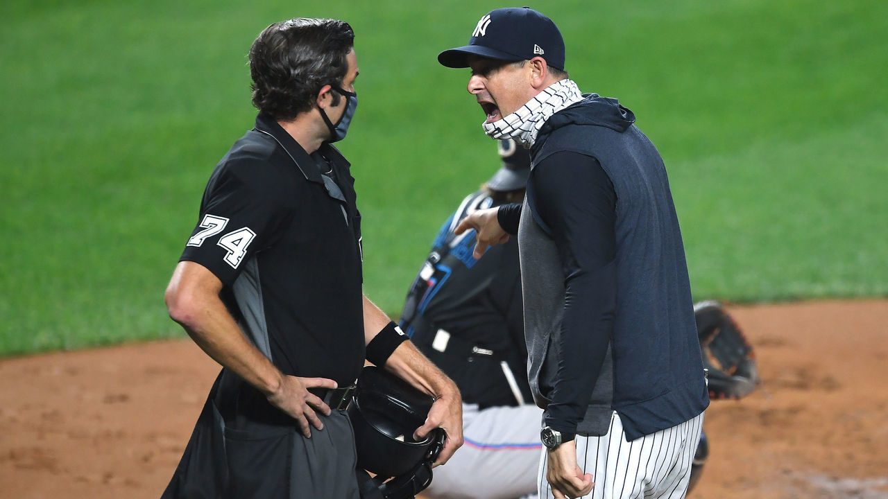 NEW YORK, NEW YORK - SEPTEMBER 25: Manager Aaron Boone #17 of the New York Yankees exchanges words with umpire John Tumpane #74 during the first inning against the Miami Marlins at Yankee Stadium on September 25, 2020 in the Bronx borough of New York City.