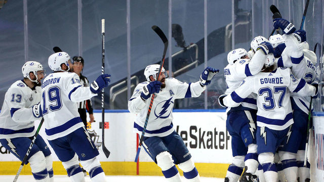 EDMONTON, ALBERTA - SEPTEMBER 25: Kevin Shattenkirk #22 of the Tampa Bay Lightning is mobbed by teammates after Shattenkirk scored the game-winning goal in the first overtime period of Game Four of the NHL Stanley Cup Final between the Tampa Bay Lightning and the Dallas Stars at Rogers Place on September 25, 2020 in Edmonton, Alberta, Canada. The Lightning defeated the Stars 5-4 in overtime.