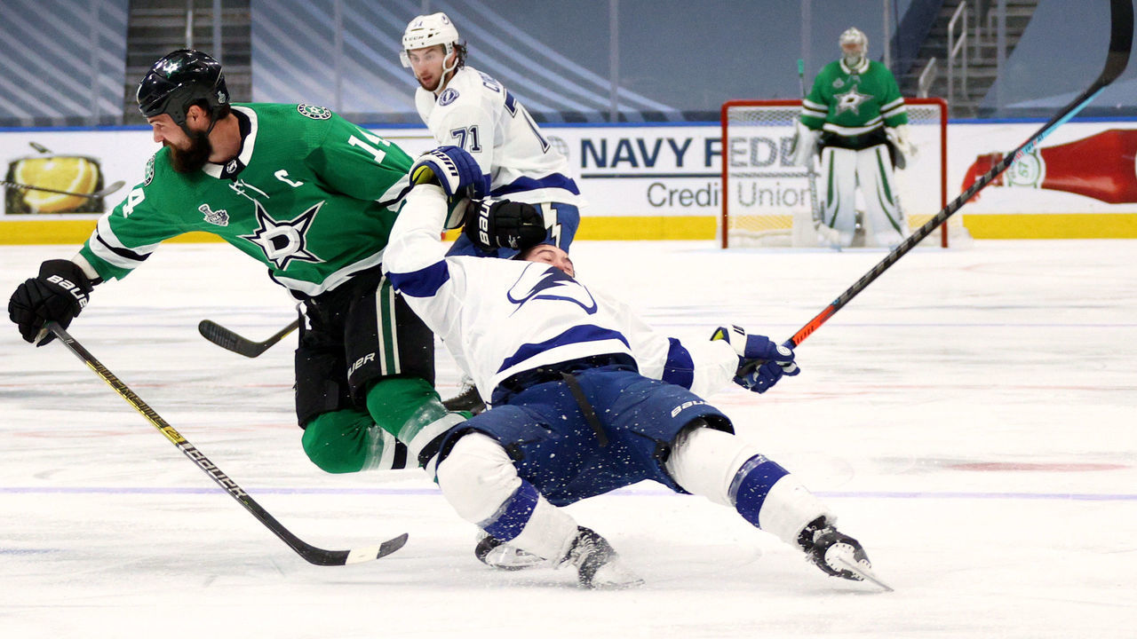 EDMONTON, ALBERTA - SEPTEMBER 25: Jamie Benn #14 of the Dallas Stars takes down Tyler Johnson #9 of the Tampa Bay Lightning in the first overtime period of Game Four of the NHL Stanley Cup Final between the Tampa Bay Lightning and the Dallas Stars at Rogers Place on September 25, 2020 in Edmonton, Alberta, Canada. Benn was given a two-minute minor penalty for tripping for the take down of Johnson.