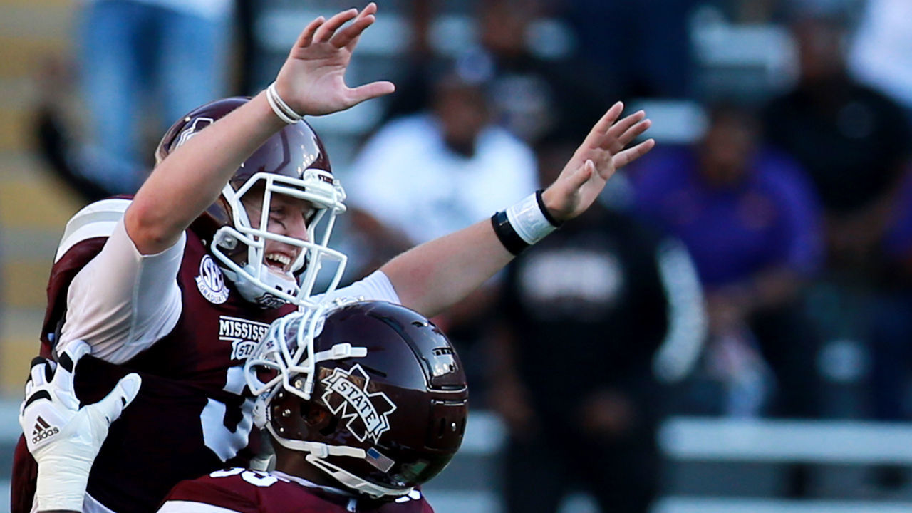 BATON ROUGE, LOUISIANA - SEPTEMBER 26: K.J. Costello #3 of the Mississippi State Bulldogs celebrates with Greg Eiland #55 of the Mississippi State Bulldogs after throwing a touchdown pass against the LSU Tigers during a NCAA football game at Tiger Stadium on September 26, 2020 in Baton Rouge, Louisiana.