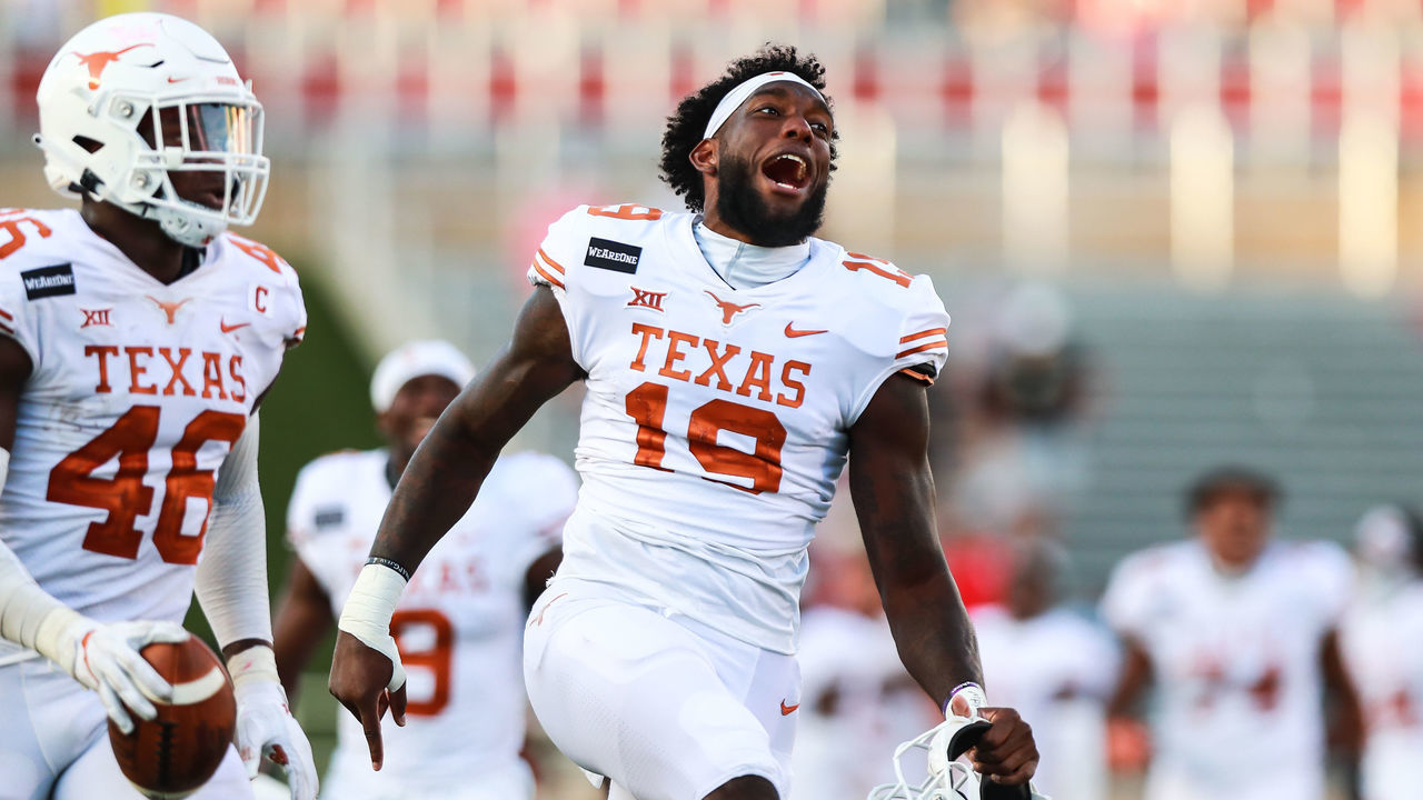 LUBBOCK, TEXAS - SEPTEMBER 26: Defender Joseph Ossai #46 and tight end Malcolm Epps #19 of the Texas Longhorns celebrate after what they thought was a game ending fumble recovery during overtime of the college football game on September 26, 2020 at Jones AT&T Stadium in Lubbock, Texas.