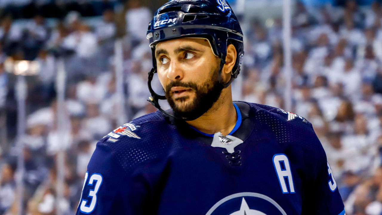 WINNIPEG, MB - APRIL 18: Dustin Byfuglien #33 of the Winnipeg Jets looks on during a second period stoppage in play against the St. Louis Blues in Game Five of the Western Conference First Round during the 2019 NHL Stanley Cup Playoffs at the Bell MTS Place on April 18, 2019 in Winnipeg, Manitoba, Canada. The Blues defeated the Jets 3-2 to lead the series 3-2.