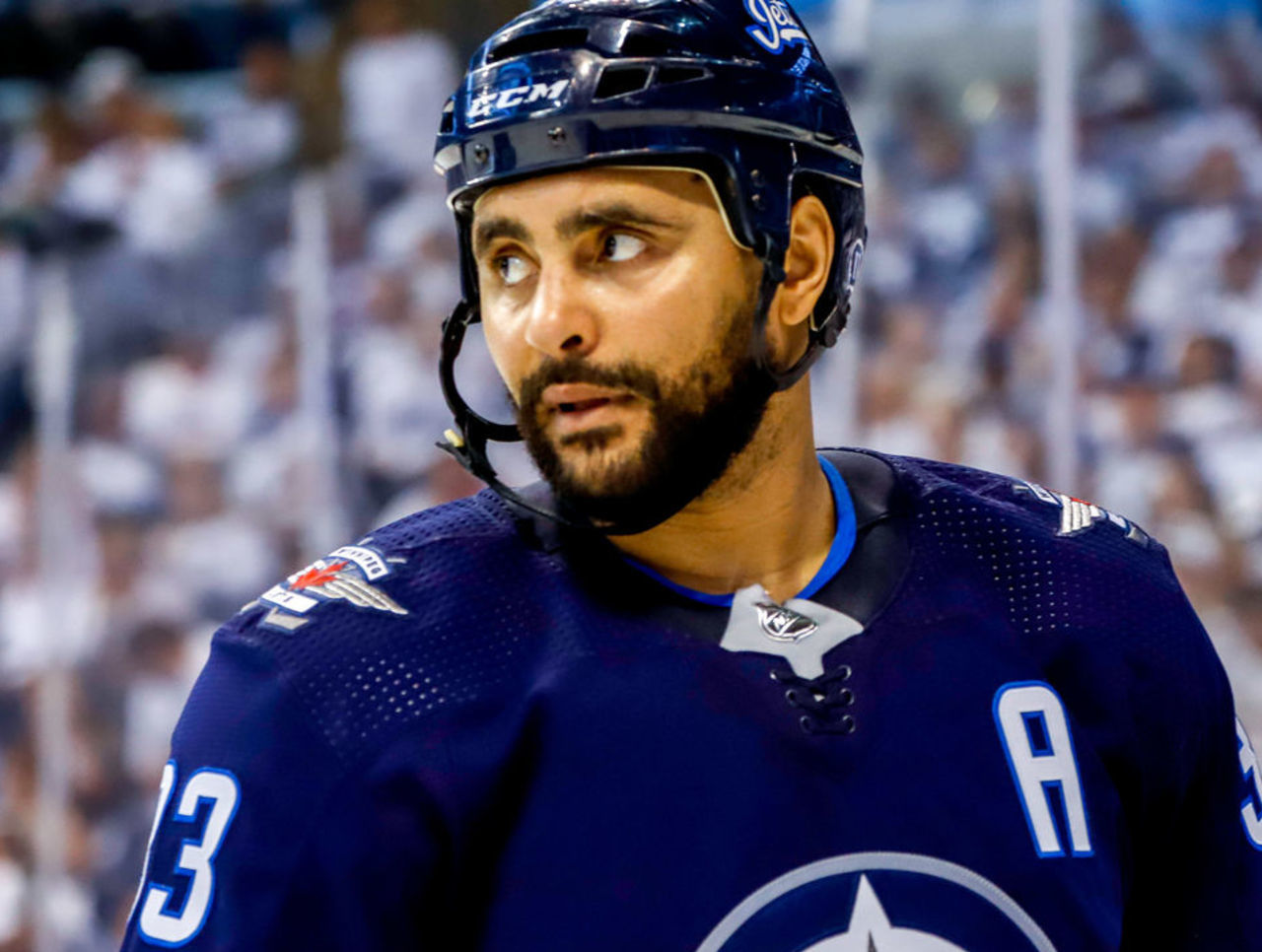 Dustin Byfuglien with two Players.